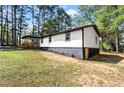 A charming side-view of the house showcasing manicured landscaping, and a glimpse of its updated exterior at 4739 Cook Sw Rd, Stockbridge, GA 30281