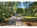 Charming home nestled among mature trees, featuring a circular driveway and well-maintained lawn at 4739 Cook Sw Rd, Stockbridge, GA 30281