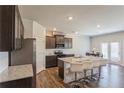 Modern kitchen features a granite countertop island with seating, stainless steel appliances, and stylish cabinetry at 4825 Layton Drive, Lithia Springs, GA 30122