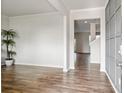 Open concept living room with luxury vinyl floors and natural light streaming through the doorway at 4825 Layton Drive, Lithia Springs, GA 30122