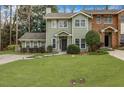 Well-manicured front yard of a lovely townhome with green lawn and mature landscaping at 250 Peachtree Hollow Ct, Atlanta, GA 30328