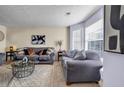 Comfortable living room with neutral tones, plush seating, and natural light at 6031 Autumn Green Dr, Fairburn, GA 30213