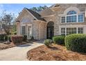 Close up of brick home featuring decorative entryway with black wrought iron doors and manicured landscaping at 2304 New Haven Pl, Conyers, GA 30094