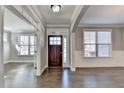 Warm and inviting entryway with hardwood floors and a view into adjoining rooms at 4217 Heisenberg Ln, Suwanee, GA 30024