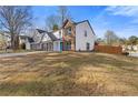 Two-story home with a two-car garage, a well-manicured lawn, and a bright blue front door at 1074 Wenham Ln, Lawrenceville, GA 30044