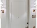 View of a neutral front door with sconces and the number 3302 to the side at 3630 Peachtree Ne Rd # 3302, Atlanta, GA 30326