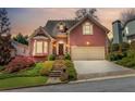 Charming two-story home with a well-manicured lawn, steps to front door, and two-car garage at 3720 Harts Pl, Atlanta, GA 30341