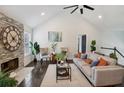 Bright living room with stone fireplace, vaulted ceilings, ceiling fan, and hardwood floors at 862 Gaston Sw St, Atlanta, GA 30310