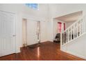 Bright foyer featuring hardwood floors, a staircase, and a soaring ceiling with skylight at 345 Timberlake Ter, Covington, GA 30016