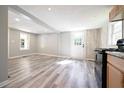 Bright, modern kitchen with new appliances and gray wood-look floors and large windows at 6886 Upshaw Mill Rd, Douglasville, GA 30134
