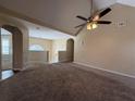 Open-concept carpeted living room featuring a ceiling fan and view to a staircase at 287 Bramlett Meadows Dr, Douglasville, GA 30134