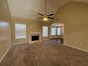 Spacious carpeted living room with a fireplace, ceiling fan, and large windows at 287 Bramlett Meadows Dr, Douglasville, GA 30134