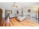 Bright living room with hardwood floors, a sectional sofa, and natural light streaming through the windows at 4525 Hickory Grove Nw Dr, Acworth, GA 30102