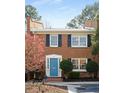 Two-story brick home with a blue front door, black shutters, and a well-maintained front garden at 4620 Wieuca Ne Rd # 32, Atlanta, GA 30342