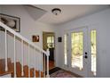 Bright foyer with staircase, a decorative glass front door, and neutral wall paint at 2112 Starfire Ne Dr, Atlanta, GA 30345