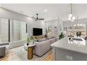 Bright living room and kitchen area with hardwood floors, large windows, and stylish modern decor at 219 Howell Se Dr # A, Atlanta, GA 30316