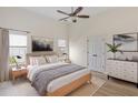 Stylishly decorated bedroom with neutral tones, two windows, and a modern dresser at 310 Tuggle Court, Woodstock, GA 30188