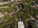 Aerial view highlights community amenities: tennis courts, pool, and clubhouse nestled in a lush landscape at 1303 Highland Bluff Se Dr # 303, Atlanta, GA 30339