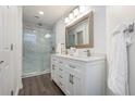 Updated bathroom with double vanity, modern lighting, and a glass-enclosed shower at 1303 Highland Bluff Se Dr # 303, Atlanta, GA 30339