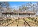 Ranch home with stone accents, shutters, and cozy front porch on a large lot at 30 Apache Ct, Locust Grove, GA 30248