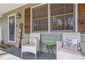 Inviting front porch with seating and charming decor at 30 Apache Ct, Locust Grove, GA 30248