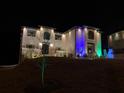 Festive two-story home adorned with colorful holiday lights and decorations at 3312 Steeple Chase Sw Way, Conyers, GA 30094