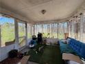 Enclosed porch with screened windows, blending indoor comfort with outdoor views at 430 N Oakland Cir, Mcdonough, GA 30253