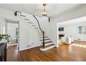 Bright foyer with hardwood floors, curved staircase, and views into the living room at 954 Winall Down Ne Rd, Atlanta, GA 30319