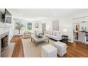 Elegant living room with hardwood floors, fireplace, and stylish white furniture at 954 Winall Down Ne Rd, Atlanta, GA 30319