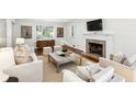 Cozy living room features a fireplace, hardwood floors, and neutral-toned furniture at 954 Winall Down Ne Rd, Atlanta, GA 30319