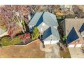 Aerial view of a two-story home with a two-car garage, manicured landscaping, and a gray shingled roof at 1920 Rosebriar Dr, Marietta, GA 30066