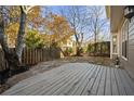 A wooden deck with a stone patio overlooks the fence-enclosed backyard area at 1920 Rosebriar Dr, Marietta, GA 30066