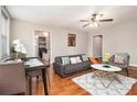 Cozy living room with hardwood floors, a dining table, and an open view into the kitchen area at 300 W Peachtree St # 21K, Atlanta, GA 30305