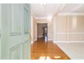 Inviting foyer with hardwood floors, light paint, a decorative doorway and an open layout at 407 Trotters Run, Woodstock, GA 30188
