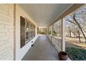 Inviting covered porch with wooden flooring and railing, offering a relaxing outdoor space at 1140 Goodwin Ne Pl, Atlanta, GA 30319