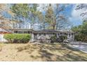 Charming single-story home featuring a brick facade, well-maintained lawn, and mature trees at 2754 Drew Valley Ne Rd, Atlanta, GA 30319