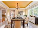 Elegant dining room with a modern chandelier, and large windows at 3510 Long Lake Dr, Douglasville, GA 30135