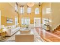 Bright living room with high ceilings, hardwood floors, and white sofas at 3510 Long Lake Dr, Douglasville, GA 30135
