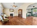 Spacious living room with hardwood floors, fireplace, and a seamless flow into the kitchen, perfect for entertaining at 610 Amberwood Pl, Euharlee, GA 30145