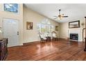 Bright living room with vaulted ceilings, fireplace, hardwood floors, and lots of natural light from the large windows at 610 Amberwood Pl, Euharlee, GA 30145