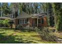 Attractive brick home with green shutters and well-manicured landscaping at 1833 Ridgeland Dr, Decatur, GA 30032