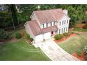 Aerial view of a two-story home featuring well-maintained landscaping, a two-car garage, and mature trees at 5166 Ridge Tarn, Acworth, GA 30102