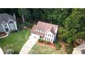 Overhead shot showcases a beautiful home with an expansive lawn, mature trees and a two-car garage at 5166 Ridge Tarn, Acworth, GA 30102