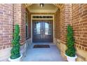 Charming front entryway with a double door and decorative plants creating a welcoming ambiance at 5910 Roxboro Ct, Cumming, GA 30040