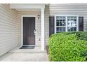 Close up of a traditional front door with side window and green hedges, framed by light-colored siding at 162 Springbottom Dr, Lawrenceville, GA 30046