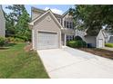 Traditional two-story home showcasing a single-car garage and fresh front lawn with an extended driveway at 162 Springbottom Dr, Lawrenceville, GA 30046