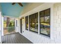 Charming front porch featuring a blue ceiling, black-framed windows, and gray stained wood flooring at 1631 Dresden Ne Dr, Brookhaven, GA 30319