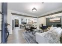 Bright, open-concept living room boasting hardwood floors, stylish furniture, and decorative wood beams at 175 Jayne Ellen Way, Alpharetta, GA 30009