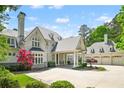 Traditional home with covered portico, porte-cochere, and an attached three car garage at 510 Covington Cv, Alpharetta, GA 30022