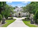 Beautiful home with meticulous landscaping, stone light fixtures, and a circular driveway at 510 Covington Cv, Alpharetta, GA 30022